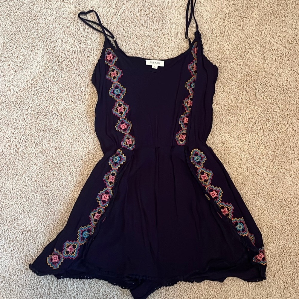 Cute navy blue romper with colorful detail.